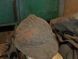 a pile of shoes and a hat sitting on the floor
