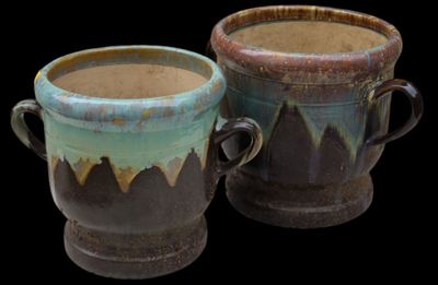 two cups that are sitting side by side on a black background