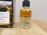 an image of a bottle of liquid sitting on top of a wooden table