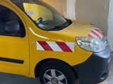 a small yellow van with a red and white stripe on the side