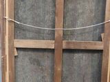 a picture of a wooden window with a wire hanging from it