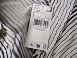 an image of a white and blue striped shirt with a tag on it