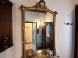 a desk with a mirror and a telephone on it