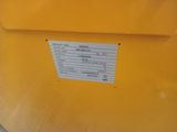 a close up of a yellow container with a sticker on it