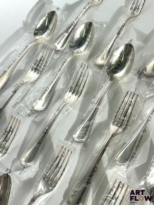 many forks and spoons in a plastic bag