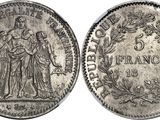 a silver coin with an image of a man and woman on it