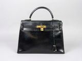 a black leather handbag on a white background