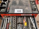 a drawer full of tools in a garage