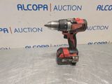 a cordless drill is shown on a table in front of a sign