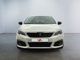 the front view of a white car in a showroom