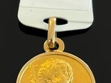 a close up of a medal on a black surface with a tag
