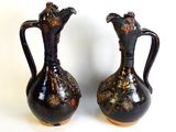 two vases that are sitting side by side on a table