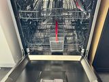 a dishwasher that is open in a kitchen