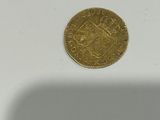 an image of a gold coin on a white surface