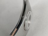 a close up of a metal object on a white surface