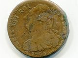 une vieille pièce de monnaie représentant une femme, sur un fond blanc