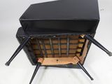 an image of a black suitcase with four legs on a white background