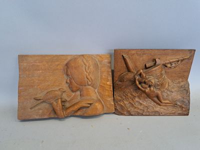 pair of carved wood plaques depicting a woman and a child