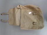 a tan bag with a tag on it sitting on a table