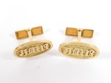 a pair of gold cufflinks with the word ' love ' engraved on them