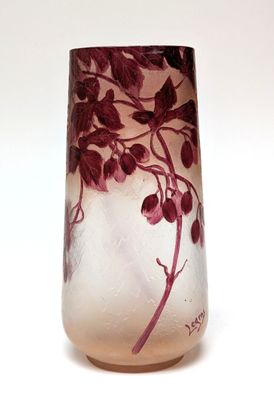 a glass vase that has a purple flower on it