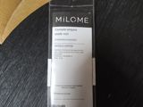 packaging of a bottle of milk sitting on a table next to a banana