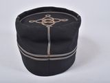 black hat with a cross on the side of it on a white surface