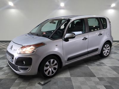 la petite voiture argentée est garée sur un carrelage à carreaux