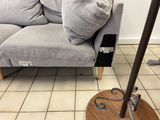 a floor lamp that is sitting on a wooden stand