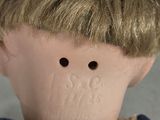 a close up of a doll ' s face with hair on it