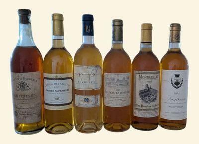 several bottles of wine are lined up on a white surface
