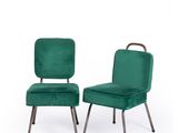 pair of green velvet chairs with metal legs