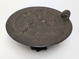 a metal object that is sitting on a white surface