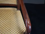 an image of a wooden chair with a yellow upholstered seat