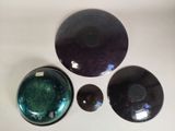 three bowls and a bowl are sitting on a white surface