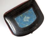 a small black box with a blue and green design on it
