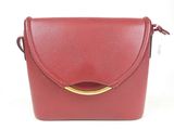red leather cross body bag with gold metal handle