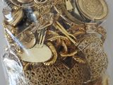 a bag full of gold and silver jewelry on a table