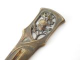 a close up of a metal object with a bird on it