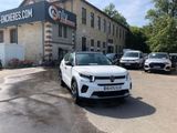 a white car parked in front of a building