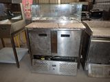 several stainless steel appliances are lined up in a warehouse