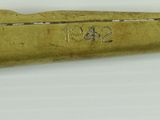 an old brass toy gun on a white surface