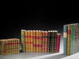 several old books are stacked on top of each other on a table