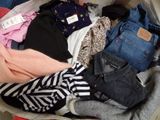 un tas de vêtements dans une valise posée par terre