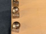 a wooden box that has a bunch of knobs on it