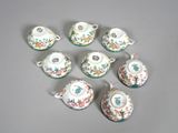 six pieces of porcelain tea set on a gray surface