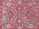 a close up of a red carpet with a floral design on it
