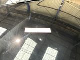 a parking meter sitting on the windshield of a car