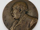 two bronze medallions with a portrait of a man on them