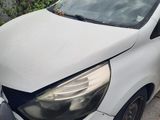 the front of a white car that has been damaged and is sitting on the side of the road